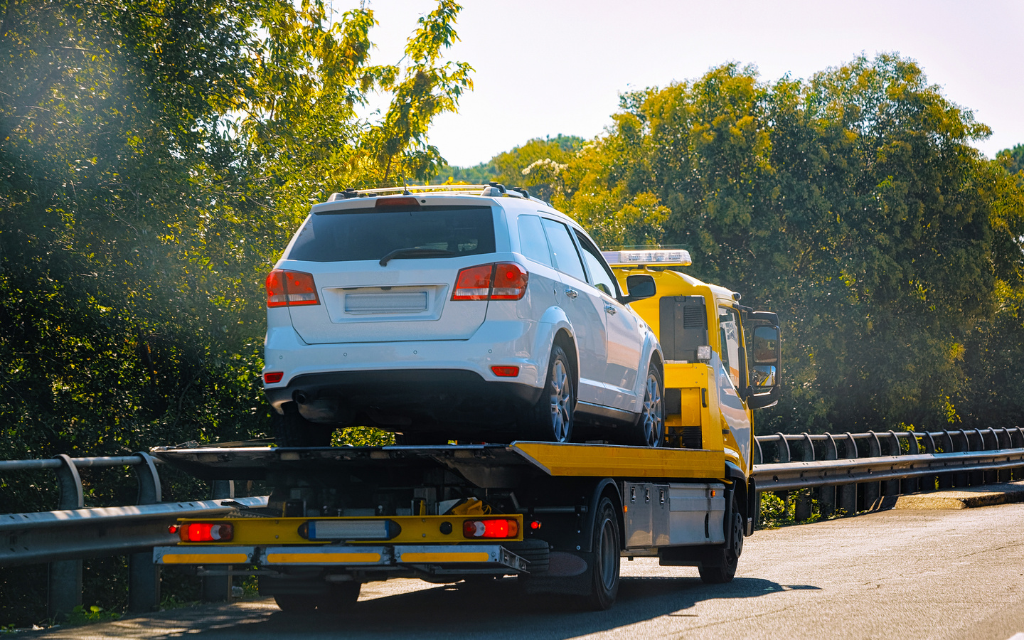 Tow Truck with Car on the Road